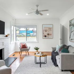 A living room with a white brick fireplace