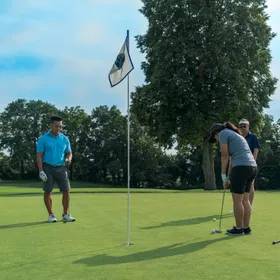Three people on a golf green